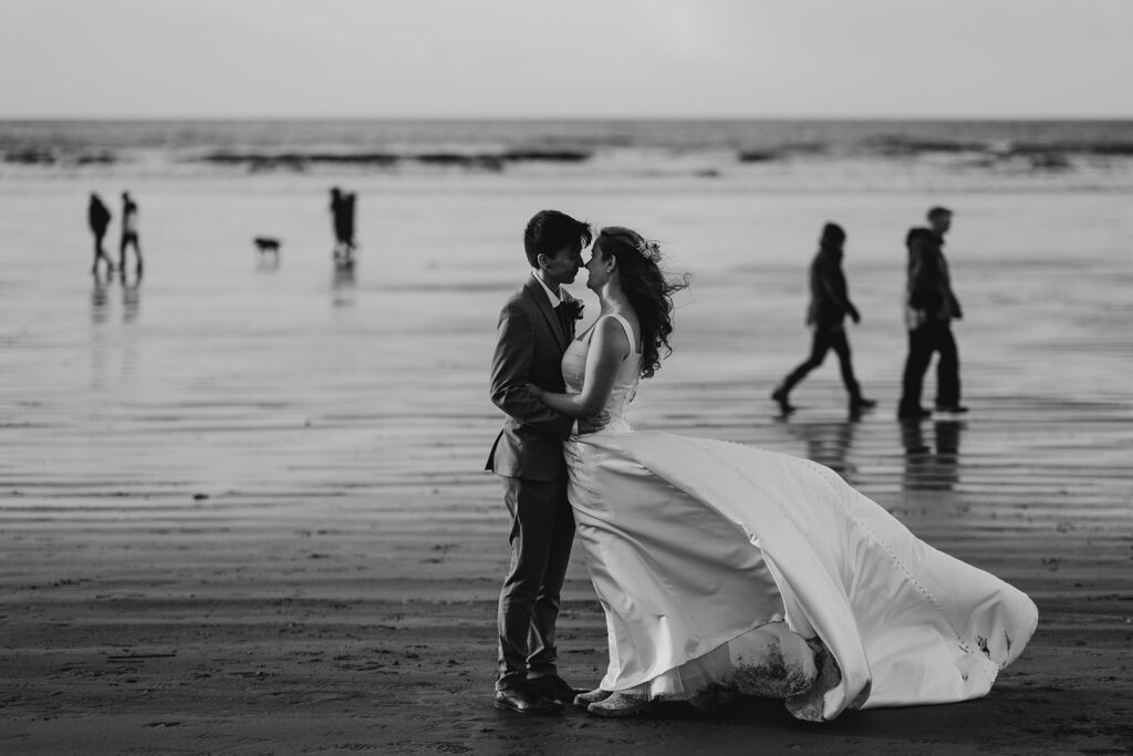 couple embrace on beach during an elopement photo shoot